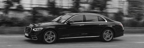 Black-and-white photograph of the entire FRALIMO Mercedes-Benz S-Class in motion.